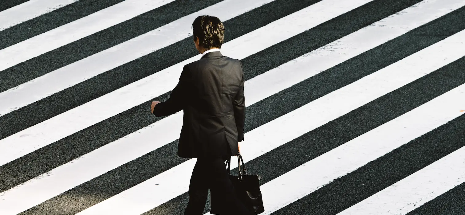 An asiatic man walking on the street